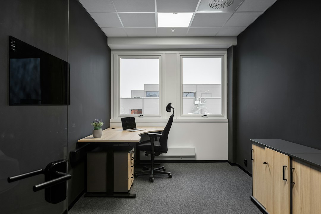 Ergonoom meet de zithoogte van een bureaustoel in een kantoor